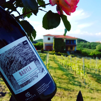 A bottle of wine from Argatia winery and the winery at the back