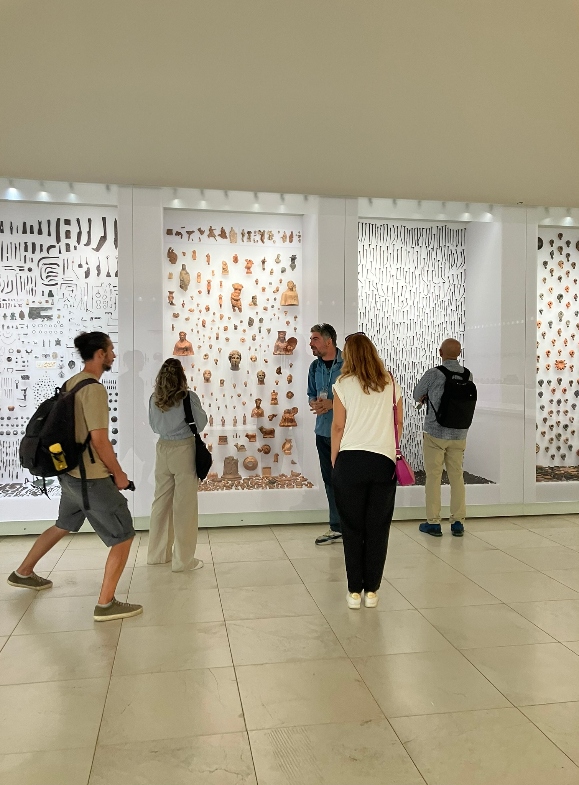 People in a museum looking and wandering in front of the displays