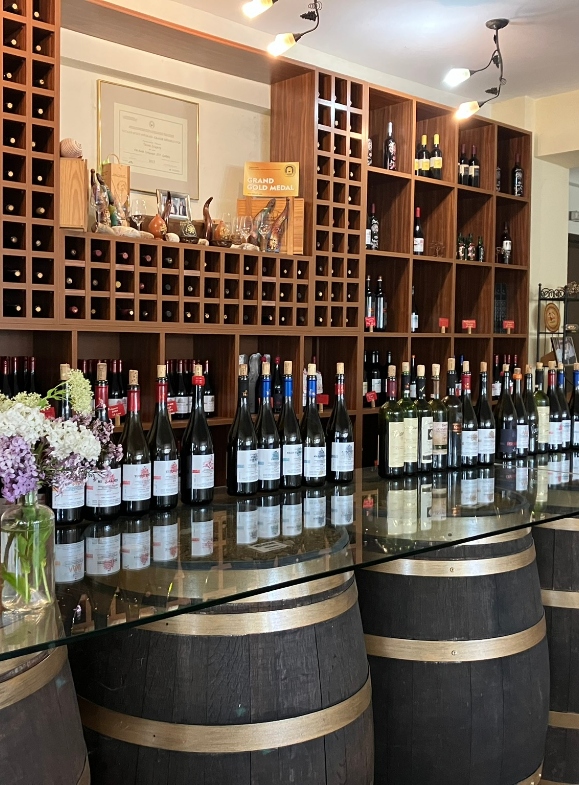 Wine tasting area with wooden barrels and wine bottles