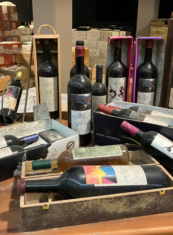 Old bottles of wine resting in the aging cellar