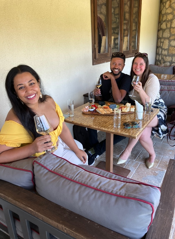 Happy group of friends tasting wine accompanied by a charcuterie board