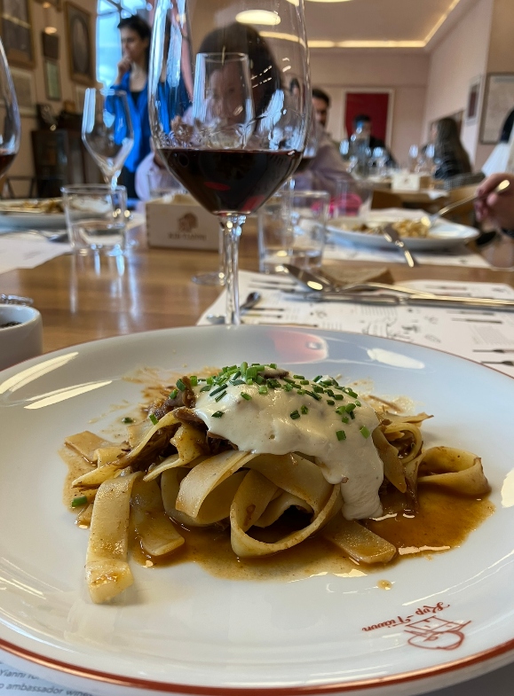 Hearty food paired with red wine during a wine tasting